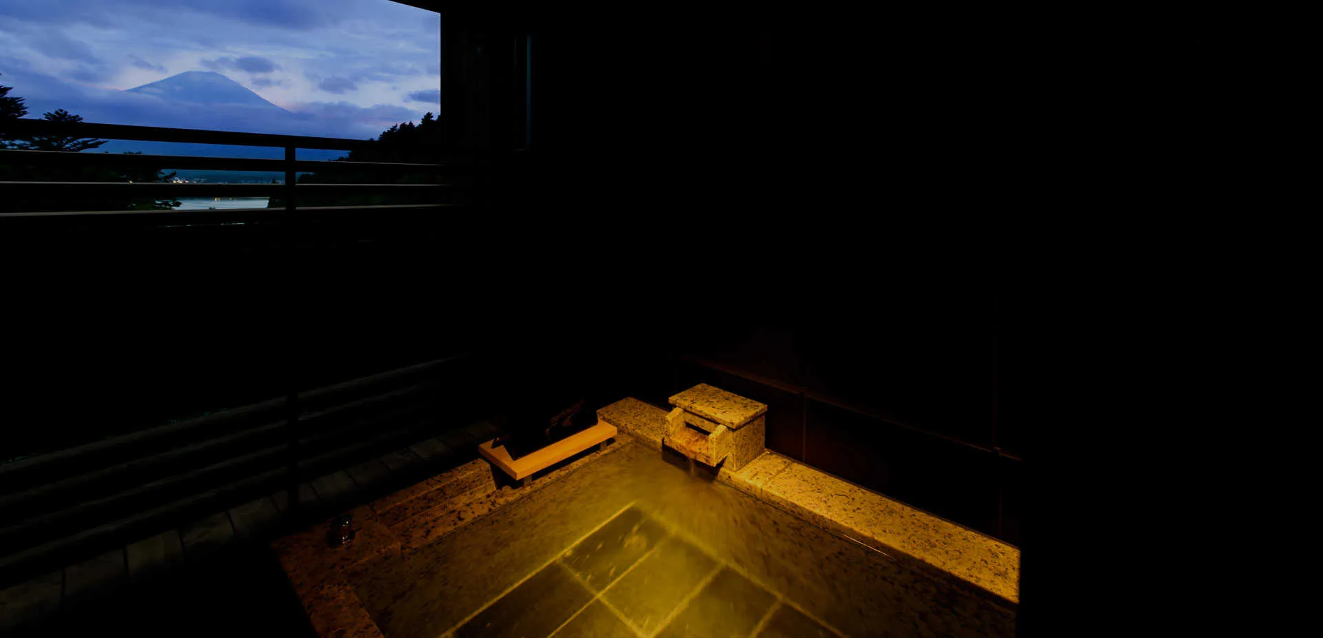 A guaranteed private open-air onsen at a luxury Kawaguchiko ryokan, offering uninterrupted views of Mount Fuji and the surrounding forest.