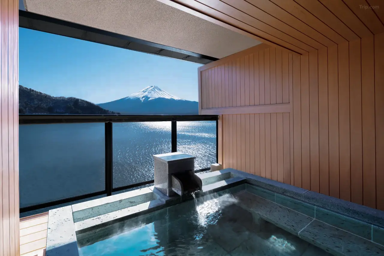 The iconic Mt. Fuji view from a private suite at Ubuya, framed by warm traditional interiors and the serene waters of Lake Kawaguchi.
